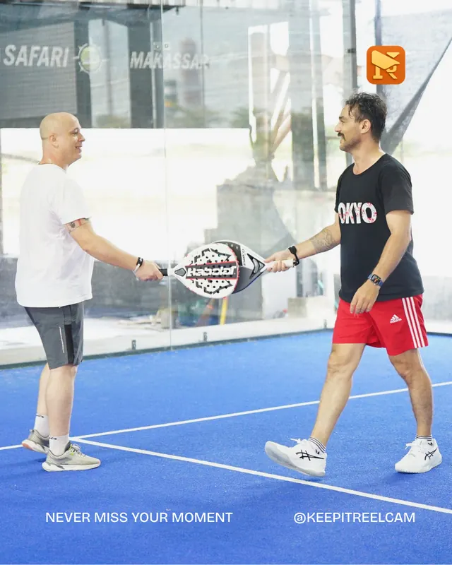 Padel players shake hands after a game.